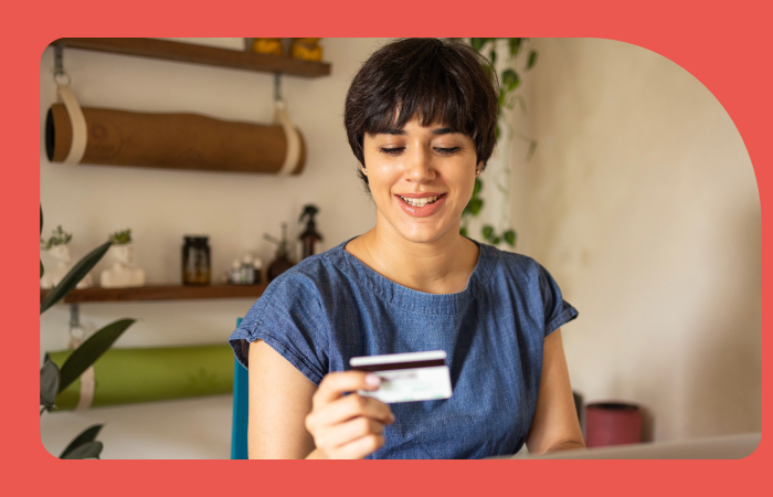 Mujer mirando tarjeta BancoEstado 